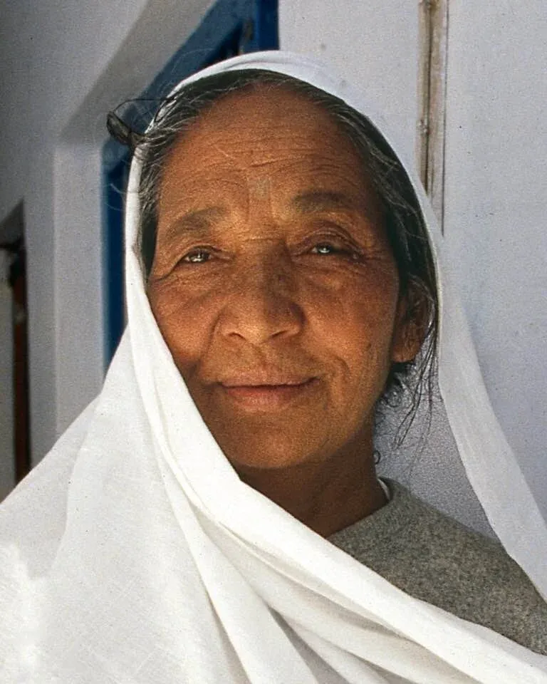 Shri Siddhi Maa in a white sari, smiling gently