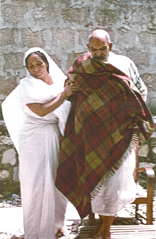Siddhi Maa wrapping a blanket around Neem Karoli Baba